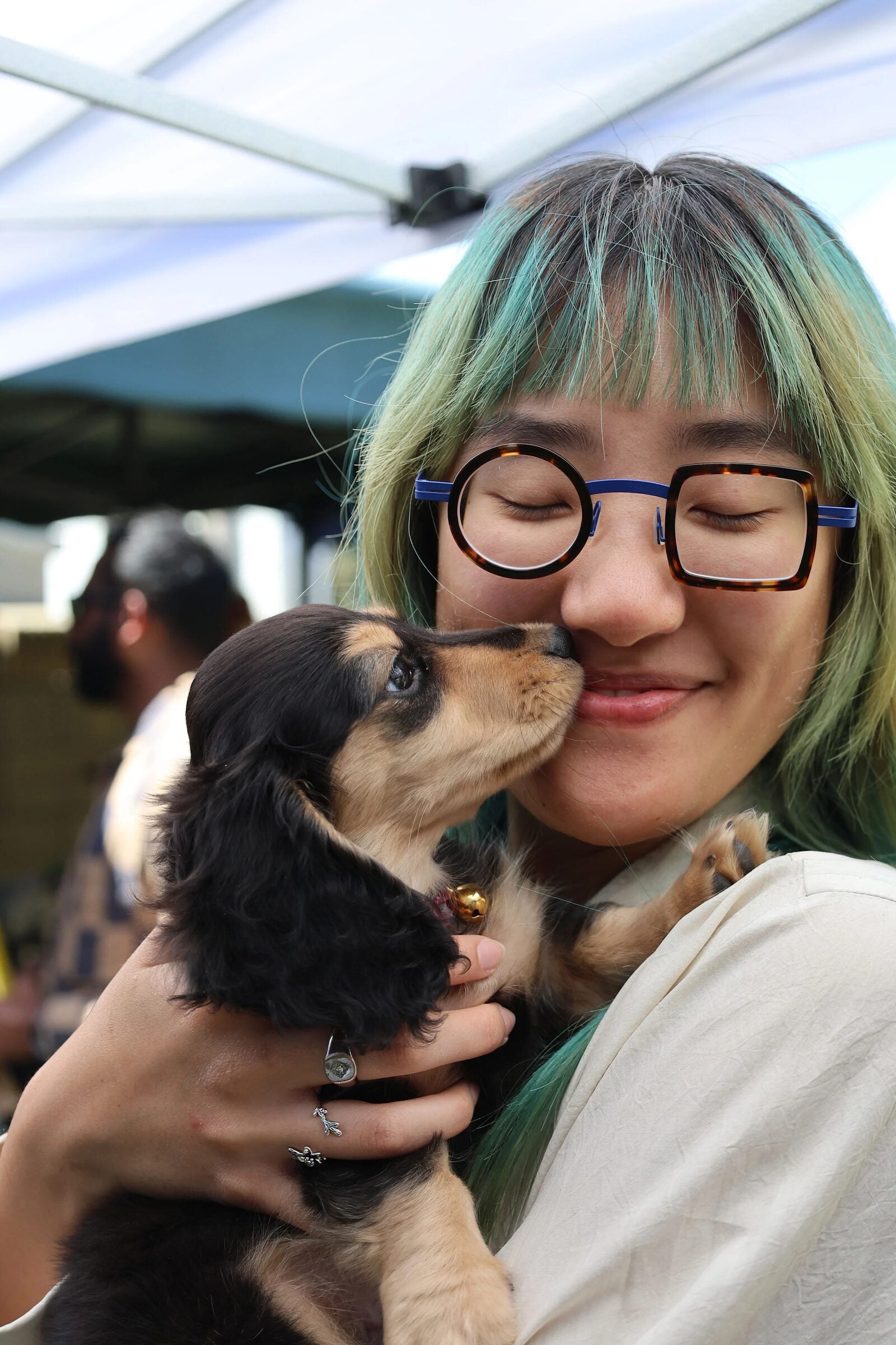 Guest cuddling a puppy at the market